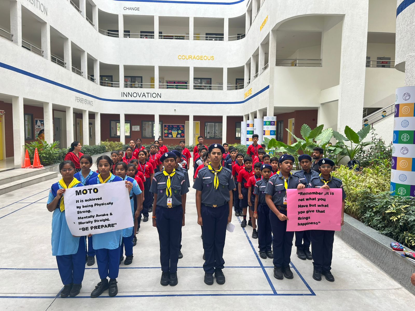 Scouts and Guides leading a rally with posters promoting kindness in Meru International School